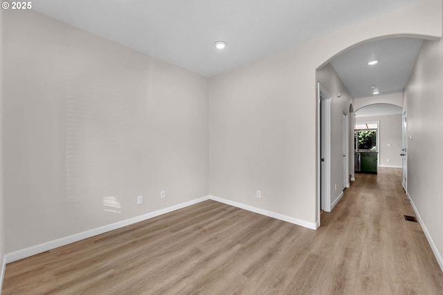 3707 NE Minnehaha St, Vancouver, WA 98661 - spare room featuring light wood-style flooring, visible vents, baseboards, arched walkways, and recessed lighting