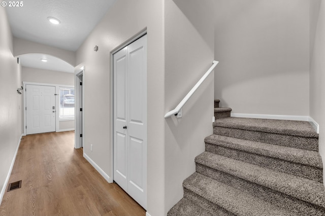 3707 NE Minnehaha St, Vancouver, WA 98661 - staircase featuring arched walkways, baseboards, visible vents, and wood finished floors
