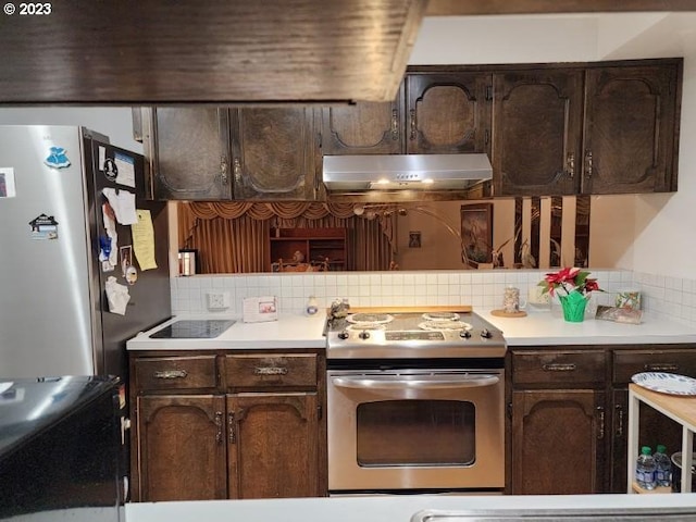 kitchen featuring backsplash, dark brown cabinets, and appliances with stainless steel finishes