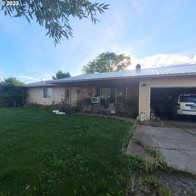 single story home with cooling unit, a garage, and a front lawn