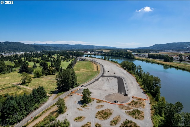 birds eye view of property with a water and mountain view