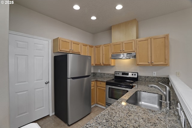 kitchen featuring under cabinet range hood, light brown cabinetry, appliances with stainless steel finishes, and a sink