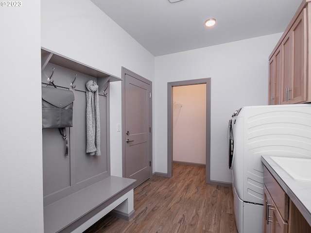 mudroom with light hardwood / wood-style flooring and washer / dryer