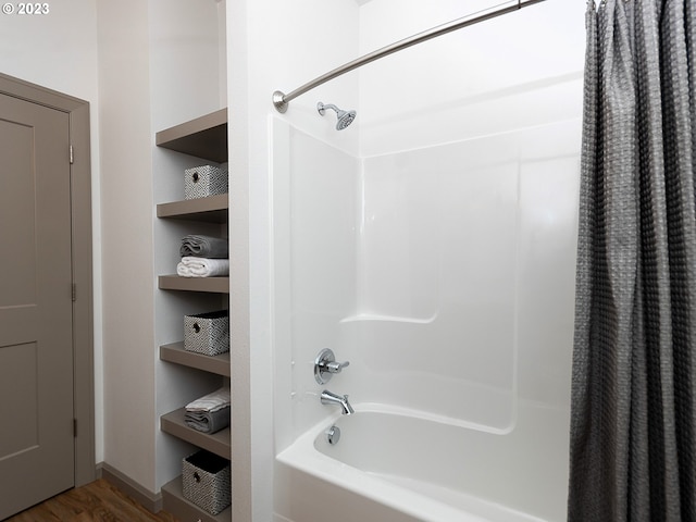 bathroom featuring shower / bath combo with shower curtain and hardwood / wood-style flooring