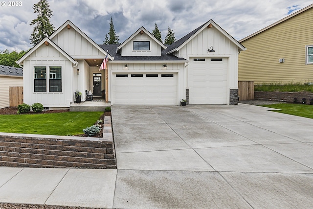 modern inspired farmhouse featuring a front lawn and a garage