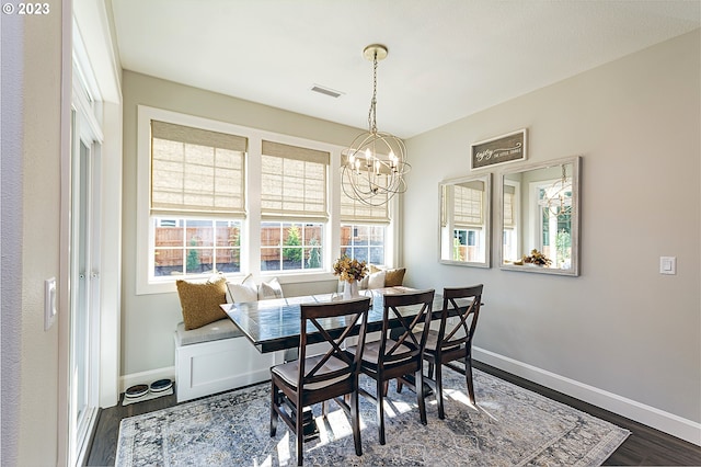 dining space featuring a chandelier and dark wood-type flooring