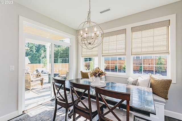 dining space featuring an inviting chandelier and hardwood / wood-style floors