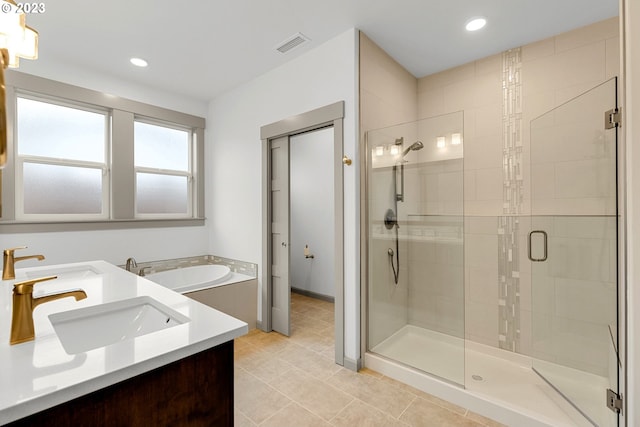 bathroom featuring tile floors, plus walk in shower, and double vanity