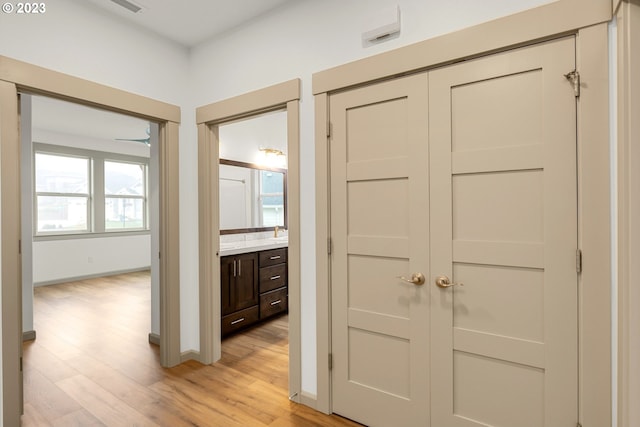 hall featuring sink and light hardwood / wood-style floors