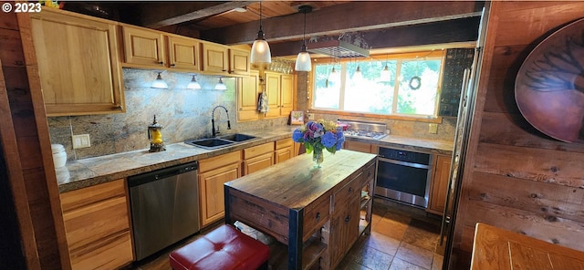 kitchen with appliances with stainless steel finishes, decorative light fixtures, tasteful backsplash, and sink