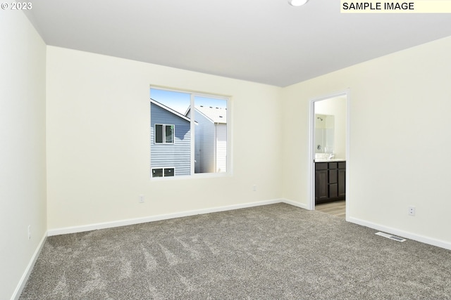 unfurnished room featuring light carpet