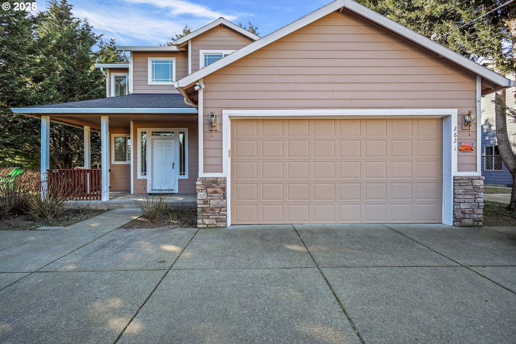 2821 SE 129th Ave, Portland, OR 97236 - view of front of property with a garage and a porch