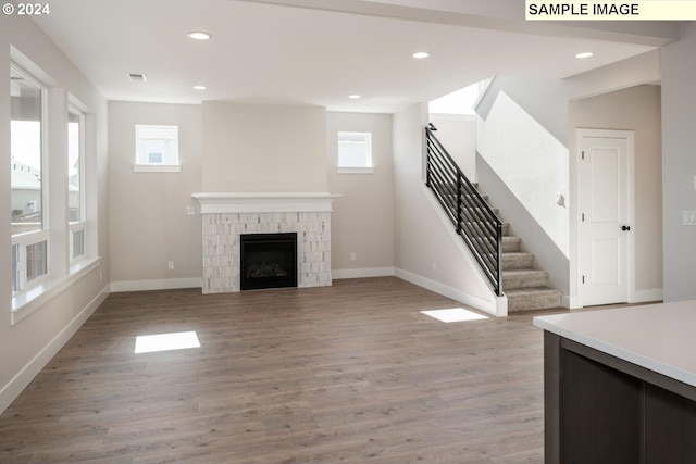 12445 SW Trask St, Beaverton, OR 97007 - unfurnished living room with baseboards, visible vents, stairs, and light wood-style flooring