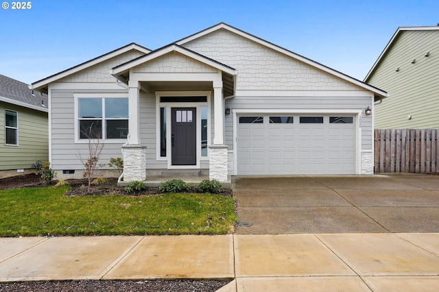 craftsman house with a garage and a front lawn