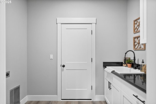 bathroom with hardwood / wood-style flooring and vanity