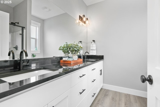 bathroom featuring hardwood / wood-style flooring and vanity