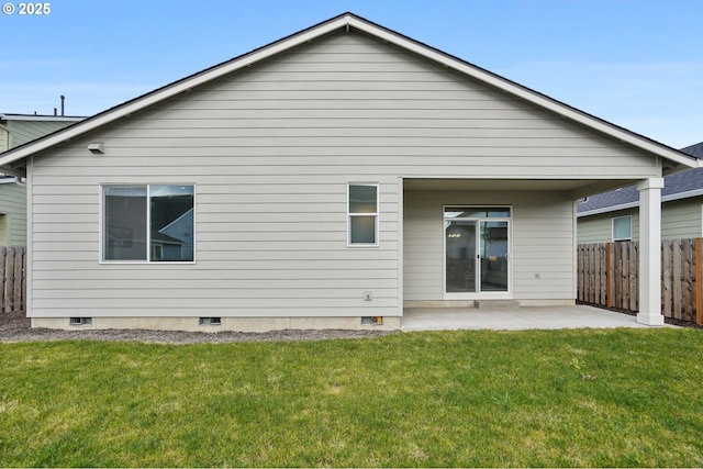 back of property featuring a patio and a yard