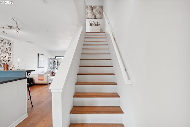 stairs featuring light hardwood / wood-style flooring