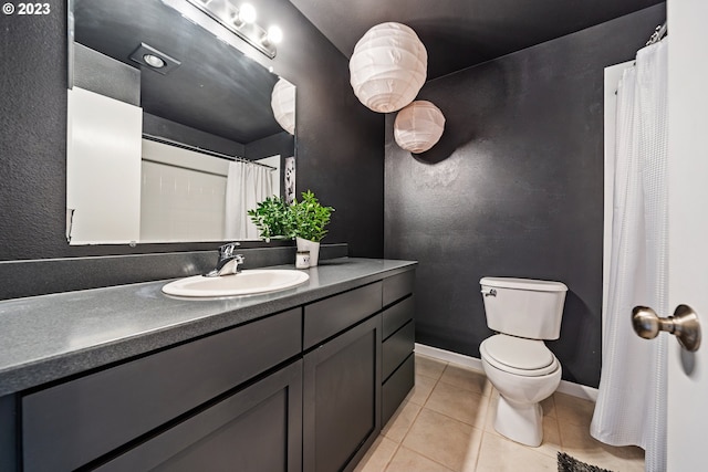 bathroom featuring tile floors, oversized vanity, and toilet