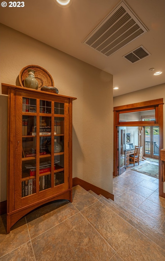 hallway with tile flooring