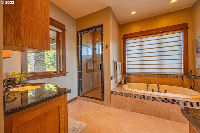 bathroom featuring separate shower and tub, tile flooring, and vanity