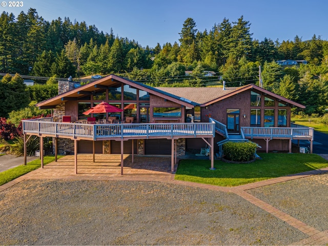 log-style house with a deck and a front lawn