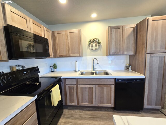 731 NE 11th St, Hermiston, OR 97838 - kitchen with black appliances, a sink, light countertops, backsplash, and recessed lighting