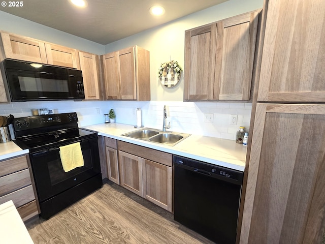 731 NE 11th St, Hermiston, OR 97838 - kitchen featuring black appliances, a sink, light wood-style floors, light countertops, and recessed lighting