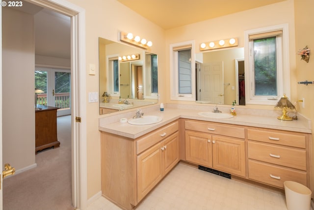 bathroom featuring tile floors and double sink vanity