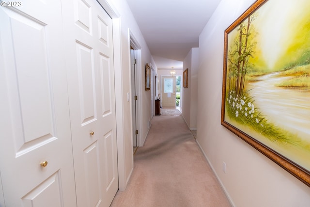 hallway with light colored carpet