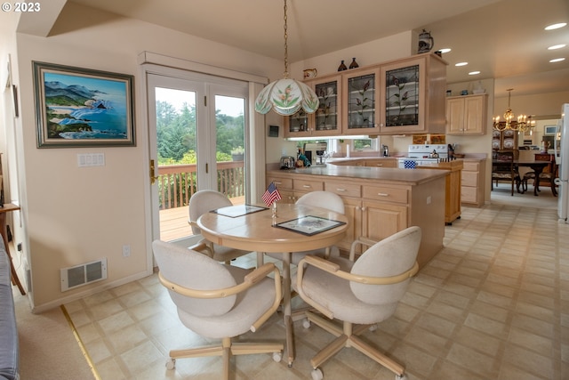 dining space with light tile floors and an inviting chandelier