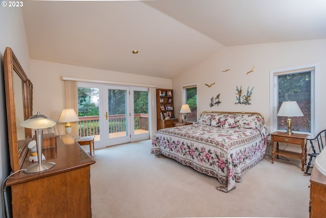 carpeted bedroom featuring lofted ceiling and access to exterior