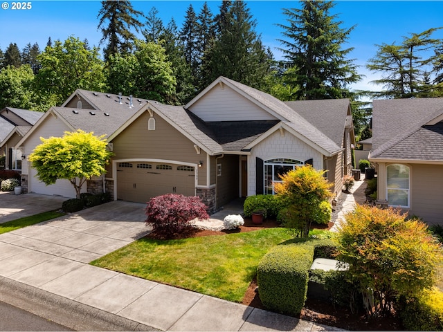 craftsman-style home with a garage, stone siding, a shingled roof, driveway, and a front lawn