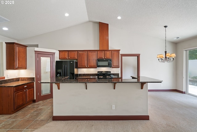 kitchen with black appliances, a kitchen bar, a chandelier, a textured ceiling, and pendant lighting