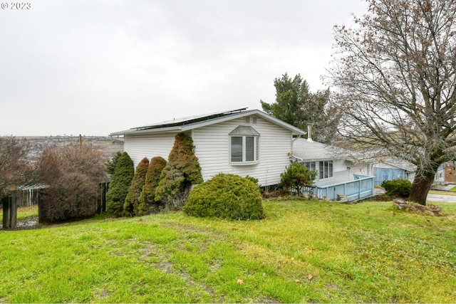 view of property exterior with a yard