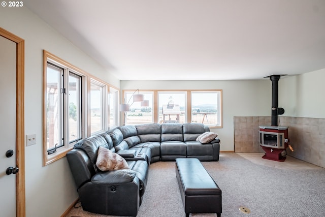 carpeted living room featuring a wood stove