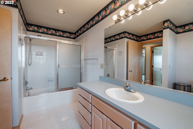 full bathroom with tile floors, bath / shower combo with glass door, oversized vanity, and toilet