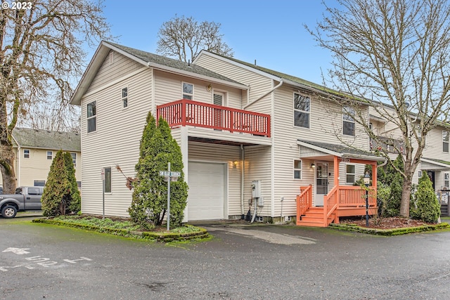 view of property with a garage and a balcony