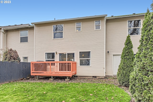 back of house featuring a deck and a yard