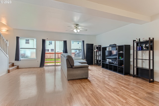 living room with light hardwood / wood-style flooring and ceiling fan