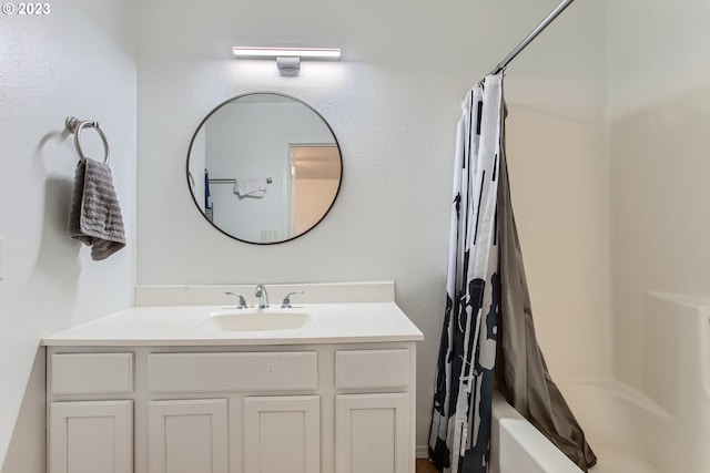 bathroom featuring shower / bath combo and vanity