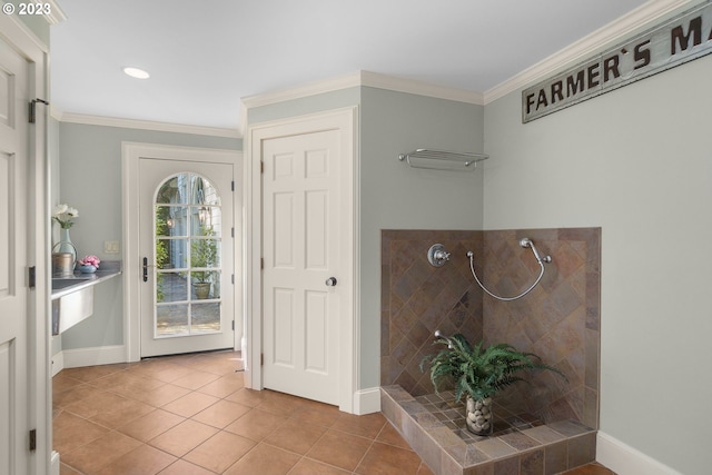 bathroom featuring crown molding, tile flooring, and a tile shower