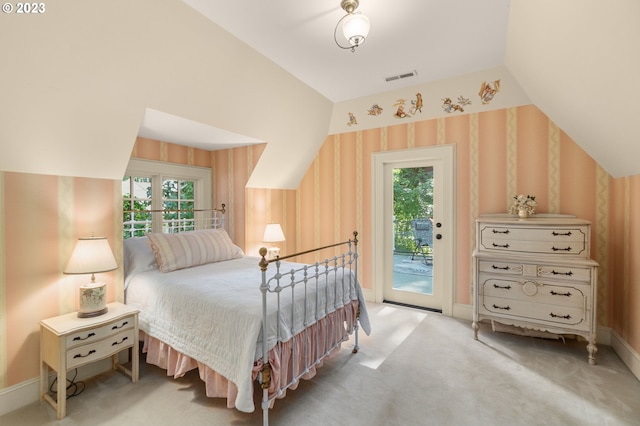 bedroom with light carpet, vaulted ceiling, and access to outside