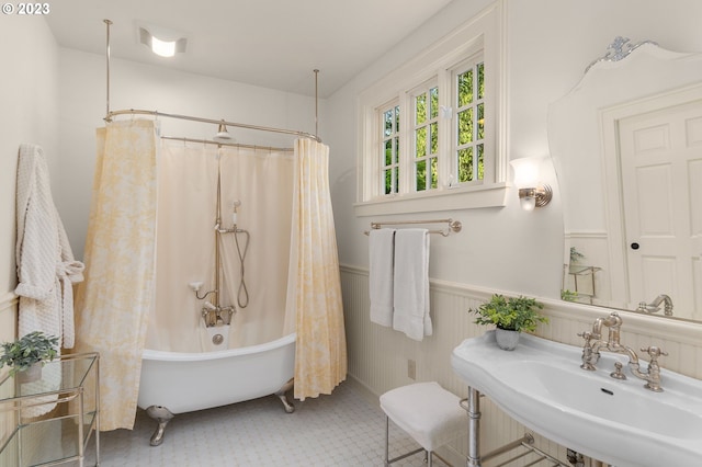 bathroom featuring shower / bath combination with curtain, tile floors, and sink