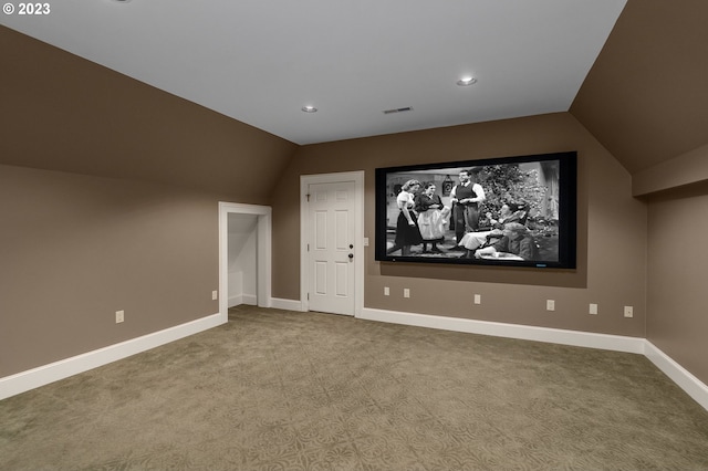 home theater room featuring dark carpet and lofted ceiling