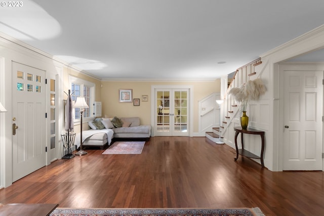 living room with dark hardwood / wood-style floors, french doors, and ornamental molding