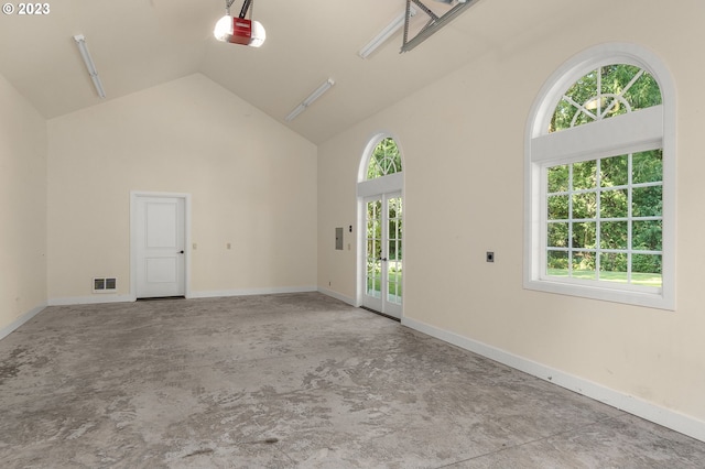 unfurnished room featuring a healthy amount of sunlight and a high ceiling