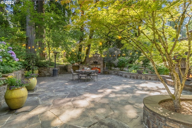 view of patio / terrace with an outdoor stone fireplace