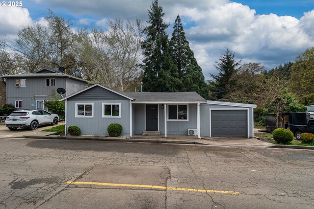 view of front of property with an attached garage, covered porch, and concrete driveway