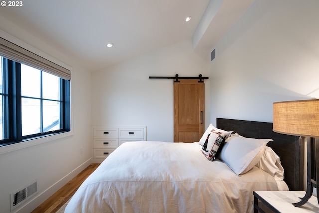 33723 Van Duyn Rd, Eugene, OR 97408 - bedroom featuring vaulted ceiling, wood finished floors, a barn door, baseboards, and recessed lighting